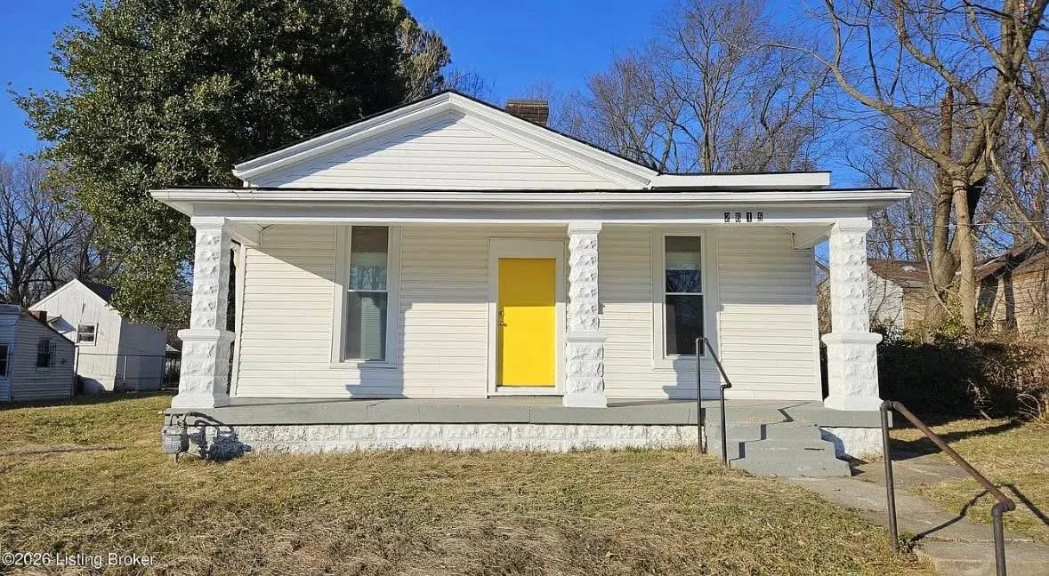 White SIG Pathway shared housing home with a yellow front door in Louisville KY